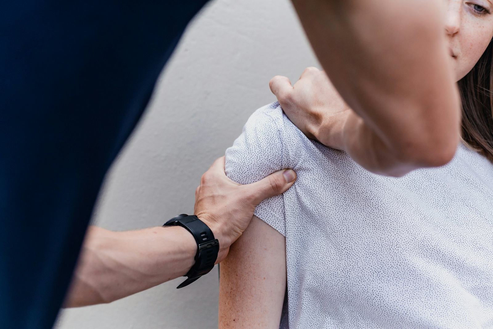 Physiotherapist treating a patient’s shoulder
